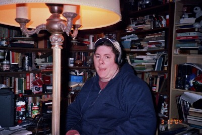 Robyn talking to her friend in China via Skype.  Notice the two sets of head phones.  A good many of the books in this photo made it to the basement May 23, 2004.