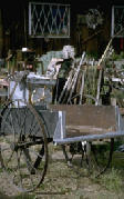 photo of wheel barrow and other assorted "junk"  for sale maybe